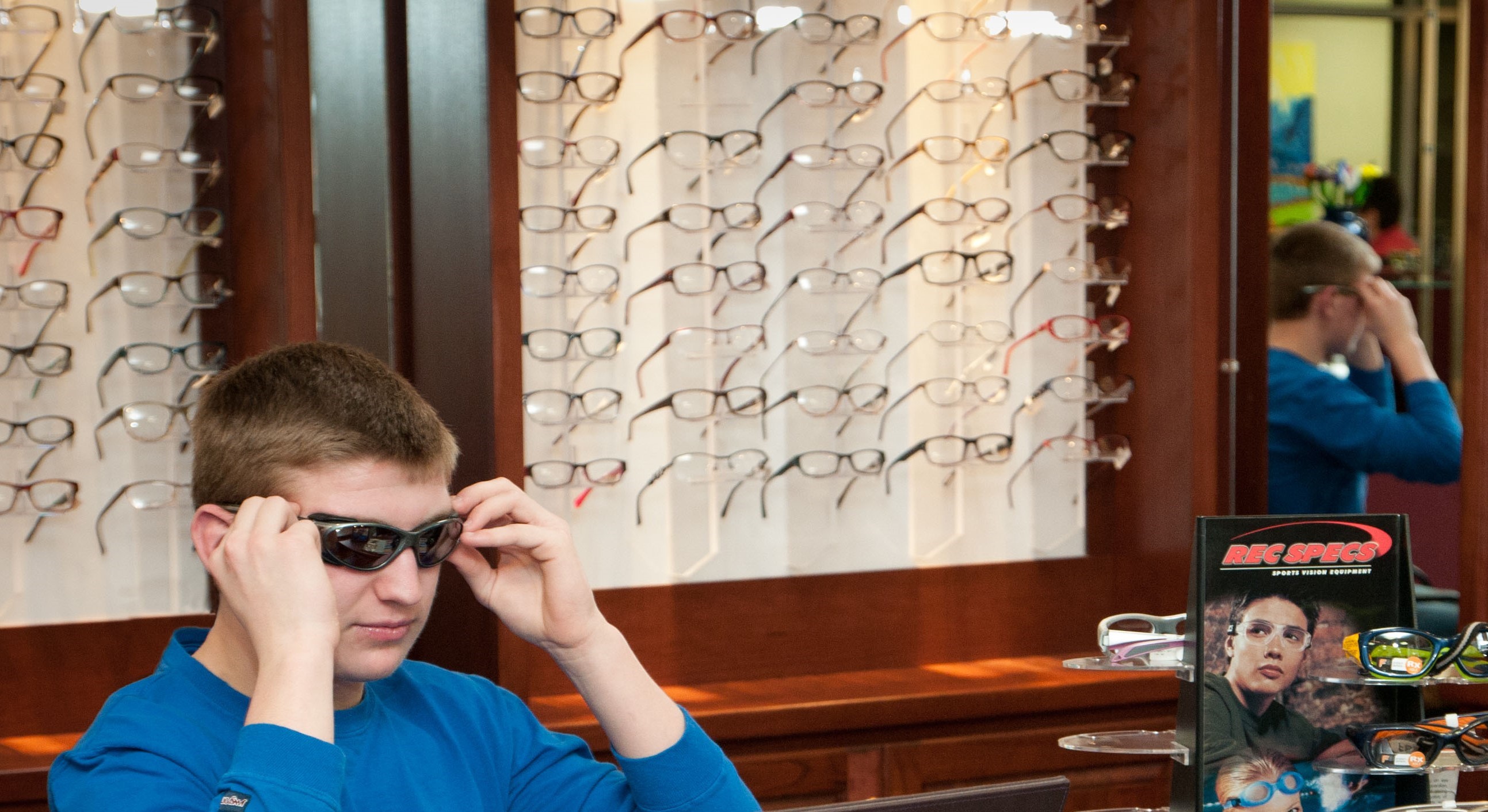 Man trying out new sporty sunglasses at Eye & Vision Clinics, S.C.