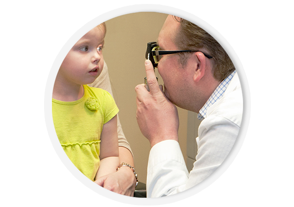Dr. Matthew Nelson conducting an eye exam on a girl.